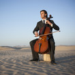 "USA, Utah, Little Sahara, young man with cello in desert"