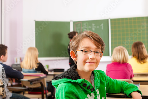 Photo: Education - teacher with pupil in school teaching Education - teacher with pupil in school teaching
