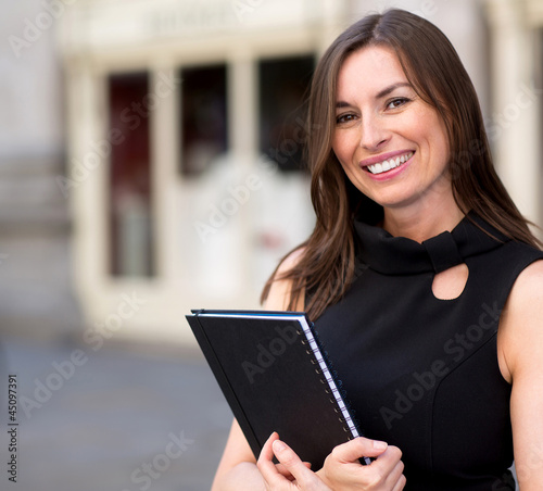 Photo: Business woman holding a folder Business woman holding a folder