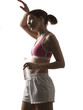 "Young woman in sportswear drinking water, studio shot"
