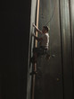 "USA, Utah, Sandy, boy climbing in indoor climbing gym, side view"