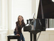 "USA, Utah, Alpine, girl (8-9) leaning to piano"