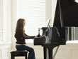 "USA, Utah, Alpine, girl (8-9) practicing piano, side view"