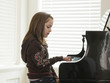 "USA, Utah, Alpine, girl (8-9) practicing piano, side view"