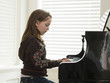 "USA, Utah, Alpine, girl (8-9) practicing piano, side view"
