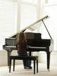 "USA, Utah, Alpine, girl (8-9) practicing piano, rear view"