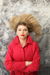 Woman with red coat lying on the floor