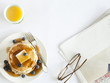 "USA, California, San Francisco, blueberry pancakes with eyeglasses and juice on table, overhead view"