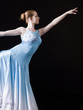 Young woman posing as professional dancer, studio shot