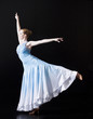 Young woman posing as professional dancer, studio shot