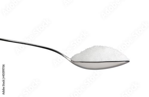 Photo: Salt or sugar on a teaspoon isolated on white background Salt or sugar on a teaspoon isolated on white background