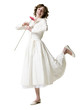 "Happy young woman dancing with gerbera flower, portrait, studio shot"