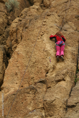 Photo: Young woman climbing Young woman climbing