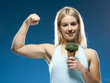 Studio portrait of young woman holding broccoli ice cream