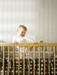 "USA, Utah, Provo, Baby boy (18-23 months) climbing in crib"