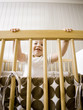 "USA, Utah, Provo, Portrait of baby boy (18-23 months) in crib"