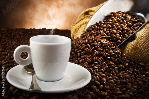 Photo: Coffee smoking on the coffee beans background Coffee smoking on the coffee beans background