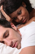 Woman watching man asleep
