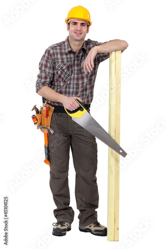 Photo: Casual carpenter stood with wood Casual carpenter stood with wood