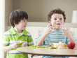 USA, Utah, Two playful boys (4-5, 6-7) at kitchen table