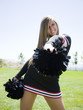 USA, Utah, American Fork, Portrait of smiling cheerleader holding pom-pom