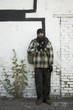 USA, Utah, Salt Lake City, Homeless man standing in front of brick wall