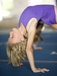 USA, Utah, Orem, Girl (8-9) stretching in gym