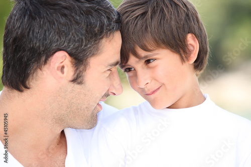Photo: a father and his son looking each other in the eyes a father and his son looking each other in the eyes