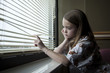 USA, Utah, Payson, Girl (8-9) looking through window