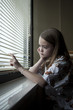 USA, Utah, Payson, Girl (8-9) looking through window