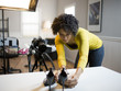 USA, Utah, Orem, Young woman preparing high heels for photograph