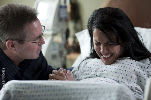 Photo: USA, Utah, Payson, Man watching wife giving birth USA, Utah, Payson, Man watching wife giving birth