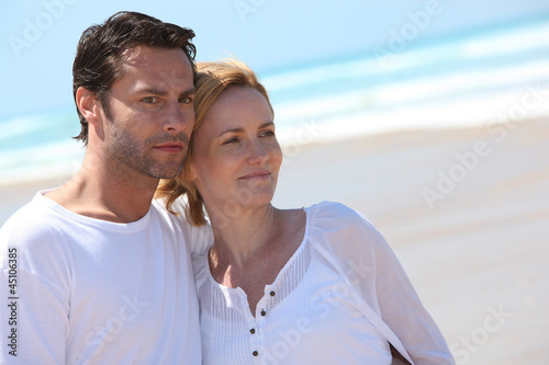 Photo: Couple relaxing on the beach Couple relaxing on the beach