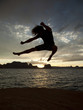 "USA, Utah, Young man jumping by Lake Powell"