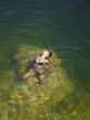"USA, Utah, Young woman relaxing in Lake Powell"