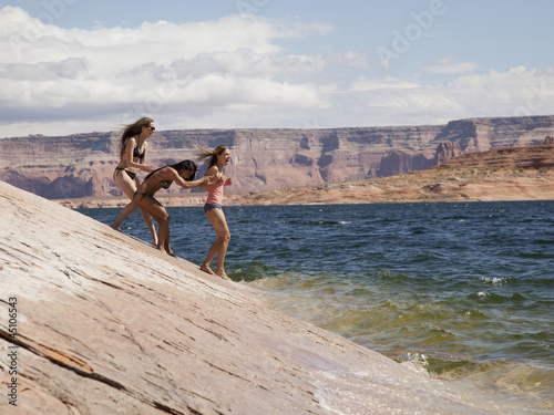 Photo: "USA, Utah, Young women standing near Lake Powell" "USA, Utah, Young women standing near Lake Powell"