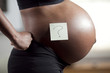 Profile of pregnant young woman's abdomen