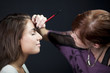 "USA, Utah, Orem, Young woman having make-up applied"