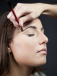 "USA, Utah, Orem, Young woman having make-up applied"
