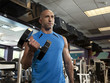 "USA, Utah, Draper, Man exercising in gym"