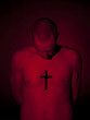 Young man with cross tattooed on chest