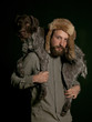 Studio portrait of young man carrying dog over shoulders