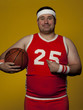 Studio portrait of young man holding basketball