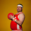 Studio portrait of young man holding playground ball