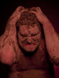 Angry young man covered in mud