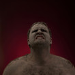 Studio shot of man covered with dirt and mud