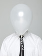 Photo: Studio portrait of young man wearing shirt and tie with face covered by white balloon Studio portrait of young man wearing shirt and tie with face covered by white balloon