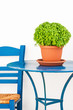 Foto: Blue chair and table with basil flowerpot Blue chair and table with basil flowerpot