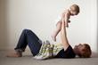 "USA, Utah, Orem, Mother playing with shirtless baby (6-11 months)"