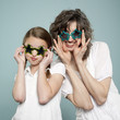 Studio shot of mother and daughter (10-11) wearing star shaped sunglasses